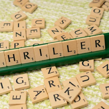 pexels photo 18524145 18524145 Wooden Scrabble tiles forming the word 'Thriller' on a game board. Perfect for book lovers.