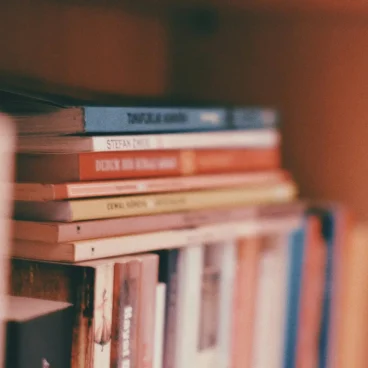 pexels photo 20310343 20310343 Closeup of stacked books on a wooden bookshelf, perfect for educational or literary themes.