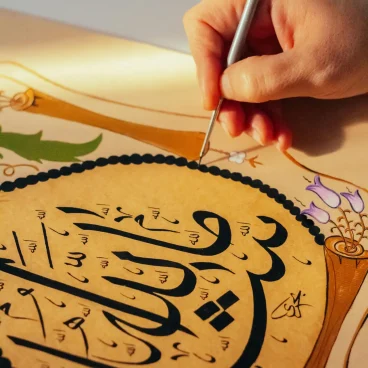 pexels photo 30834814 30834814 Close-up of hand painting Arabic calligraphy with intricate details.